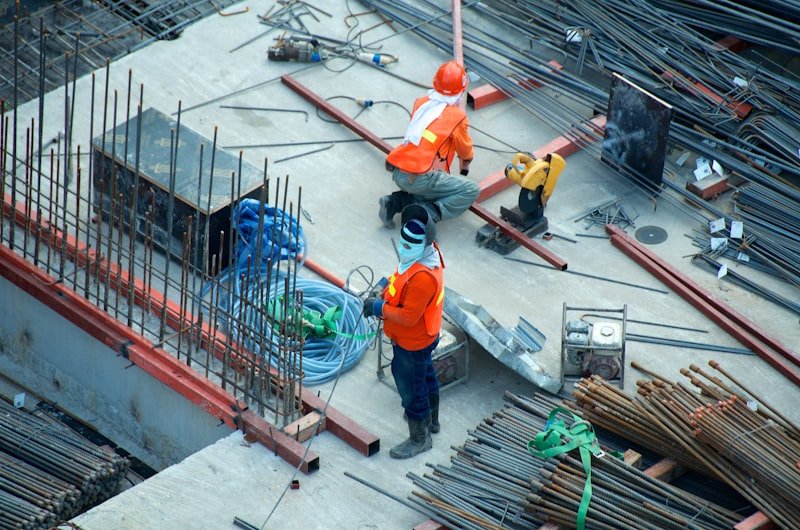 Male builder reviewing construction site progress
